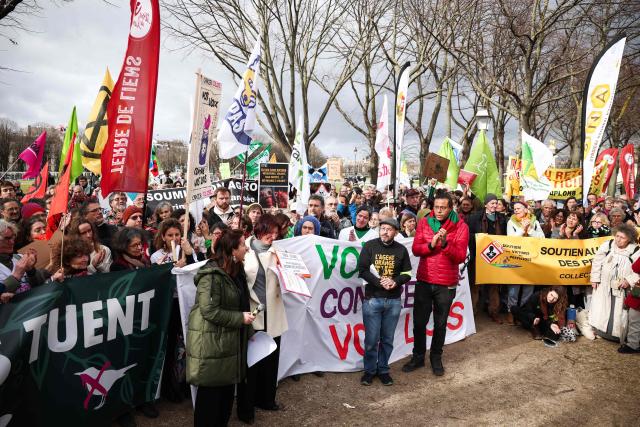 Laure Marivain (C-L) mother of Emmy and Sabine Grataloup (C), mother of Theo speak during a demonstration for agriculture, the environment and health, against the Duplomb law, at the initiative of dozens of NGOs and farmers' organizations, in front of the National Assembly in Paris on February 11, 2026. Senator Laurent Duplomb's law, adopted by Parliament in early July, facilitates water storage and the expansion of livestock buildings. But another measure concentrated indignation: the conditional reintroduction of acetamiprid, a pesticide from the neonicotinoid family banned in France but authorized elsewhere in Europe and accused of being a "bee killer" by its critics. (Photo by Guillaume BAPTISTE / AFP)