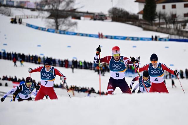 Norway's Jens Luraas Oftebro (L), Austria's Stefan Rettenegger and Norway's Einar Luraas Oftebro compete in the cross-country of the nordic combined individual Gundersen normal hill/10km event at Tesero Cross Country Stadium at Lago di Tesero (Val di Fiemme) during the Milano Cortina 2026 Winter Olympic Games on February 11, 2026. (Photo by Tobias SCHWARZ / AFP)
