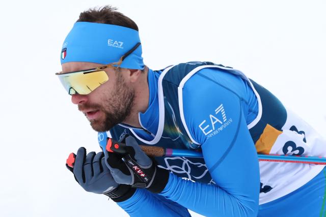 Italy's Alessandro Pittin competes in the cross-country of the nordic combined individual Gundersen normal hill/10km event at Tesero Cross Country Stadium at Lago di Tesero (Val di Fiemme) during the Milano Cortina 2026 Winter Olympic Games on February 11, 2026. (Photo by Anne-Christine POUJOULAT / AFP)
