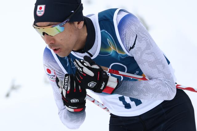 Japan's Akito Watabe competes in the cross-country of the nordic combined individual Gundersen normal hill/10km event at Tesero Cross Country Stadium at Lago di Tesero (Val di Fiemme) during the Milano Cortina 2026 Winter Olympic Games on February 11, 2026. (Photo by Anne-Christine POUJOULAT / AFP)