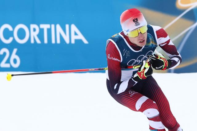 Austria's Stefan Rettenegger competes in the cross-country of the nordic combined individual Gundersen normal hill/10km event at Tesero Cross Country Stadium at Lago di Tesero (Val di Fiemme) during the Milano Cortina 2026 Winter Olympic Games on February 11, 2026. (Photo by Anne-Christine POUJOULAT / AFP)