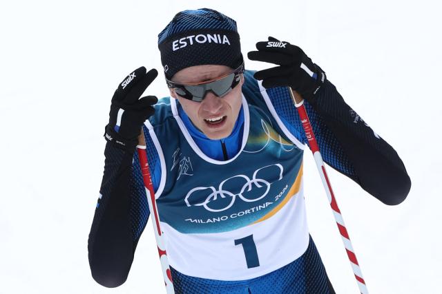 Estonia's Kristjan Ilves reacts after competing in the cross-country of the nordic combined individual Gundersen normal hill/10km event at Tesero Cross Country Stadium at Lago di Tesero (Val di Fiemme) during the Milano Cortina 2026 Winter Olympic Games on February 11, 2026. (Photo by Anne-Christine POUJOULAT / AFP)