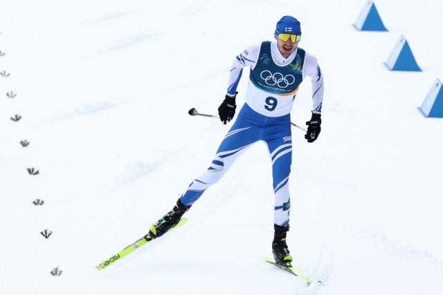 Finland's Ilkka Herola skies to the finish line as he competes in the cross-country of the nordic combined individual Gundersen normal hill/10km event at Tesero Cross Country Stadium at Lago di Tesero (Val di Fiemme) during the Milano Cortina 2026 Winter Olympic Games on February 11, 2026. (Photo by Anne-Christine POUJOULAT / AFP)