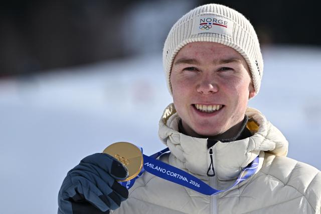Gold medallist Norway's Jens Luraas Oftebro celebrates on the podium following the nordic combined individual Gundersen normal hill/10km event at Tesero Cross Country Stadium at Lago di Tesero (Val di Fiemme) during the Milano Cortina 2026 Winter Olympic Games on February 11, 2026. (Photo by Javier SORIANO / AFP)