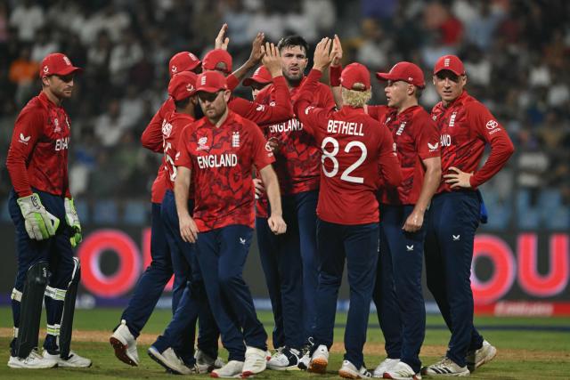 England's Jamie Overton (C) celebrates with teammates after taking the wicket of West Indies' Shimron Hetmyer during the 2026 ICC Men's T20 Cricket World Cup group stage match between England and West Indies at the Wankhede Stadium in Mumbai on February 11, 2026. (Photo by Indranil MUKHERJEE / AFP)