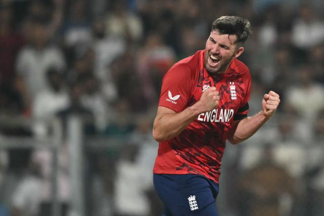 England's Jamie Overton celebrates after taking the wicket of West Indies' Shimron Hetmyer during the 2026 ICC Men's T20 Cricket World Cup group stage match between England and West Indies at the Wankhede Stadium in Mumbai on February 11, 2026. (Photo by Indranil MUKHERJEE / AFP)