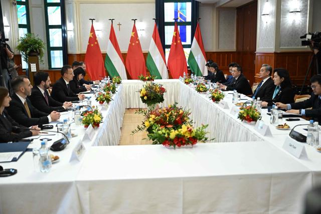 Hungarian Foreign and Trade Minister Peter Szijjarto (4th L) talks with his guest, Chinese Foreign Minister Wang Yi (3rd R) as they meet in Budapest, Hungary, on February 11, 2026. (Photo by Attila KISBENEDEK / AFP)