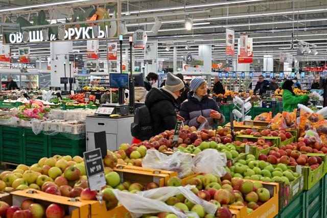 Customers shop for food in an Auchan supermarket in Aviapark shopping mall in Moscow on February 11, 2026. (Photo by Hector RETAMAL / AFP)