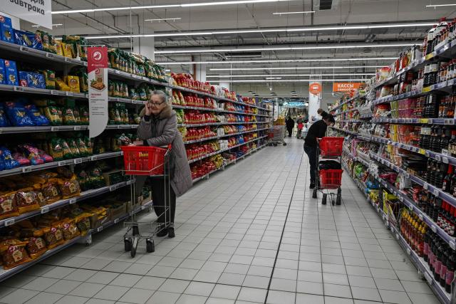 Customers shop for food in an Auchan supermarket in Aviapark shopping mall in Moscow on February 11, 2026. (Photo by Hector RETAMAL / AFP)