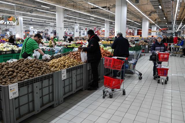 Customers shop for food in an Auchan supermarket in Aviapark shopping mall in Moscow on February 11, 2026. (Photo by Hector RETAMAL / AFP)