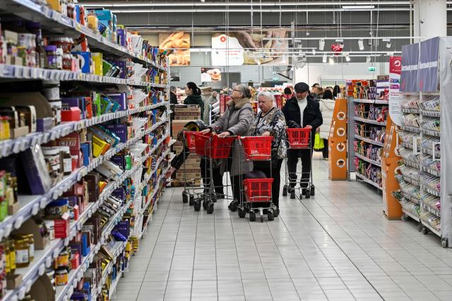 Customers shop for food in an Auchan supermarket in Aviapark shopping mall in Moscow on February 11, 2026. (Photo by Hector RETAMAL / AFP)