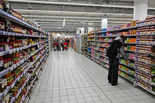 Customers shop for food in an Auchan supermarket in Aviapark shopping mall in Moscow on February 11, 2026. (Photo by Hector RETAMAL / AFP)
