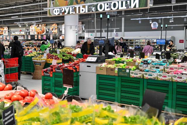 Customers shop for food in an Auchan supermarket in Aviapark shopping mall in Moscow on February 11, 2026. (Photo by Hector RETAMAL / AFP)