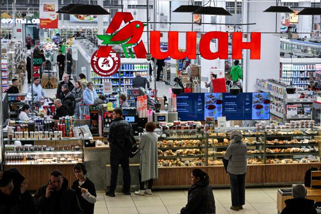 Customers shop for food in an Auchan supermarket in Aviapark shopping mall in Moscow on February 11, 2026. (Photo by Hector RETAMAL / AFP)