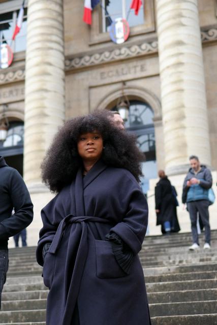 Assa Traore stands on stairs as she leaves after attending a hearing of France's top court on the dismissal of an investigation into the 2016 death of her brother Adama Traore in police custody at Paris' courthouse on February 11, 2026. The lawyer for Adama Traorй’s family, Me Yassine Bouzrou, announced that he would petition the European Court of Human Rights (ECHR) “to have France sentenced,” after the case was dismissed on February 11, 2026 by the Court of Cassation. (Photo by Thomas SAMSON / AFP)