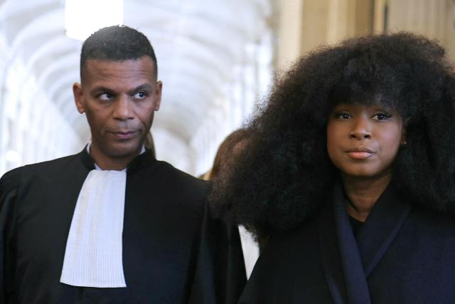 Assa Traore (R) next to French lawyer Yassine Bouzrou (L) leaves after attending a hearing of France's top court on the dismissal of an investigation into the 2016 death of her brother Adama Traore in police custody at Paris' courthouse on February 11, 2026. The lawyer for Adama Traorй’s family, Me Yassine Bouzrou, announced that he would petition the European Court of Human Rights (ECHR) “to have France sentenced,” after the case was dismissed on February 11, 2026 by the Court of Cassation. (Photo by Thomas SAMSON / AFP)