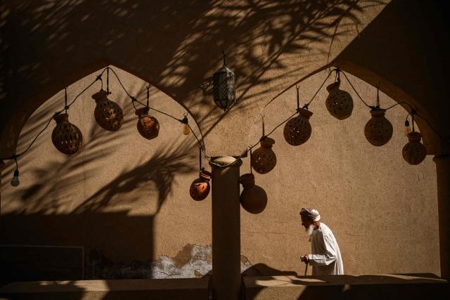 TOPSHOT - An old man walks in the souk of Nizwa, prior to the presentation of the 5th and last stage of the Tour of Oman cycling race from Nizwa to Green Mountain, on February 11, 2026. (Photo by Loic VENANCE / AFP)