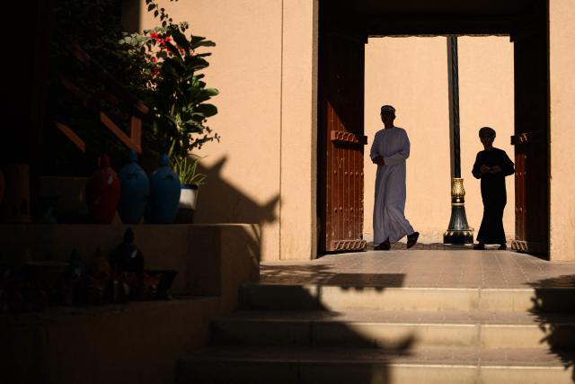 Local residents walk in the souk of Nizwa, prior to the presentation of the 5th and last stage of the Tour of Oman cycling race from Nizwa to Green Mountain, on February 11, 2026. (Photo by Loic VENANCE / AFP)