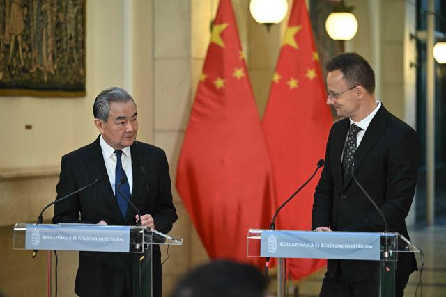 Hungarian Foreign and Trade Minister Peter Szijjarto (R) and Chinese Foreign Minister Wang Yi address a joint press conference in Budapest, Hungary, on February 11, 2026. (Photo by Attila KISBENEDEK / AFP)