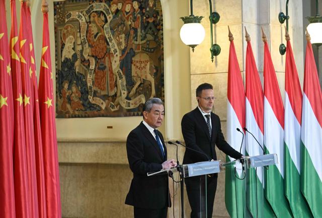 Hungarian Foreign and Trade Minister Peter Szijjarto (R) and Chinese Foreign Minister Wang Yi speak during their joint press conference in Budapest, Hungary, on February 11, 2026. (Photo by Attila KISBENEDEK / AFP)