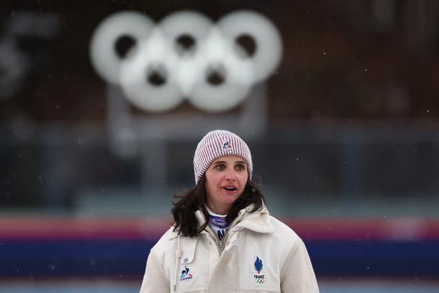 Gold medallist France's Julia Simon poses on the podium of the women's biathlon 15km individual event during the Milano Cortina 2026 Winter Olympic Games at the Anterselva Biathlon Arena (Sudtirol Arena) in Anterselva (Val Pusteria) on February 11, 2026. (Photo by FRANCK FIFE / AFP)