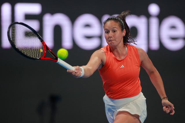 Australia’s Daria Kasatkina hits a return against Poland's Iga Swiatek during their women’s singles match at the Qatar Open tennis tournament in Doha on February 11, 2026. (Photo by Karim JAAFAR / AFP)