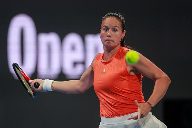 Australia’s Daria Kasatkina hits a return against Poland's Iga Swiatek during their women’s singles match at the Qatar Open tennis tournament in Doha on February 11, 2026. (Photo by Karim JAAFAR / AFP)