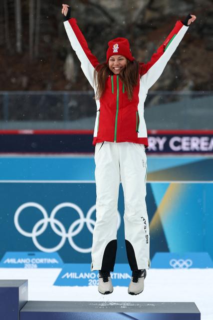 Bronze medallist Bulgaria's Lora Hristova celebrates on the podium of the women's biathlon 15km individual event during the Milano Cortina 2026 Winter Olympic Games at the Anterselva Biathlon Arena (Sudtirol Arena) in Anterselva (Val Pusteria) on February 11, 2026. (Photo by FRANCK FIFE / AFP)