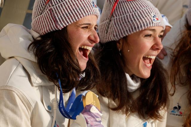 Gold medallist France's Julia Simon (L) poses with France's Camille Bened after the victory ceremony of the women's biathlon 15km individual event during the Milano Cortina 2026 Winter Olympic Games at the Anterselva Biathlon Arena (Sudtirol Arena) in Anterselva (Val Pusteria) on February 11, 2026. (Photo by Odd ANDERSEN / AFP)