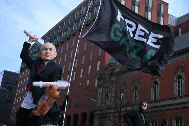 A person wearing a mask impersonating Israel Prime Minister Benjamin Netanyahu protest near the White House against the visit to the US of Netanyahu in Washington, DC, on February 11, 2026. Netanyahu said February 10 the top priority in his talks with Trump would be the ongoing negotiations with Iran, as he presses for a tougher US approach to Tehran's ballistic missile programme. (Photo by Brendan SMIALOWSKI / AFP)