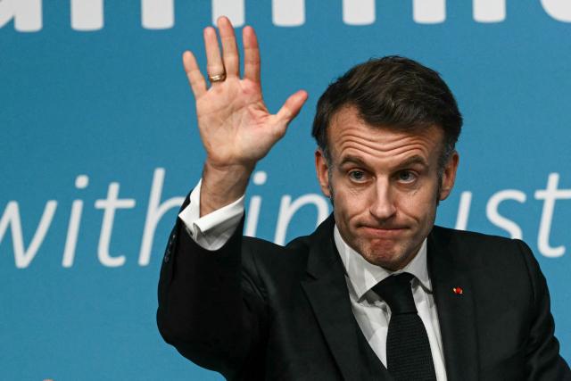 France's President Emmanuel Macron waves after delivering a speech during the European Industry Summit in Antwerp on February 11, 2026. (Photo by NICOLAS TUCAT / AFP)