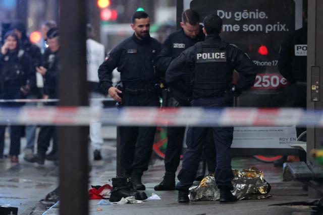 French police officers stand at a bus station in Paris on February 11, 2026 after a man armed with a knife threatened a bus driver. A man armed with a knife threatened a bus driver in Paris on February 11, 2026 and was hit by a police shot, AFP learned from police sources. (Photo by Thomas SAMSON / AFP)