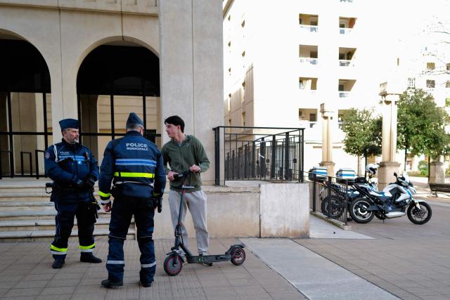 Local police officers checks the user of an electric scooter in Montpellier, southern France on February 11, 2026. The city of Montpellier issued a decree on November 2025 banning the use of electric scooters and similar vehicles in the Place de la Comédie, the Antigone district, and the main pedestrian streets of the historic center. (Photo by Sylvain THOMAS / AFP)