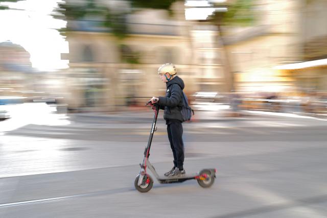 A child rides a scooter in Montpellier, southern France on February 11, 2026. The city of Montpellier issued a decree on November 2025 banning the use of electric scooters and similar vehicles in the Place de la Comédie, the Antigone district, and the main pedestrian streets of the historic center. (Photo by Sylvain THOMAS / AFP)