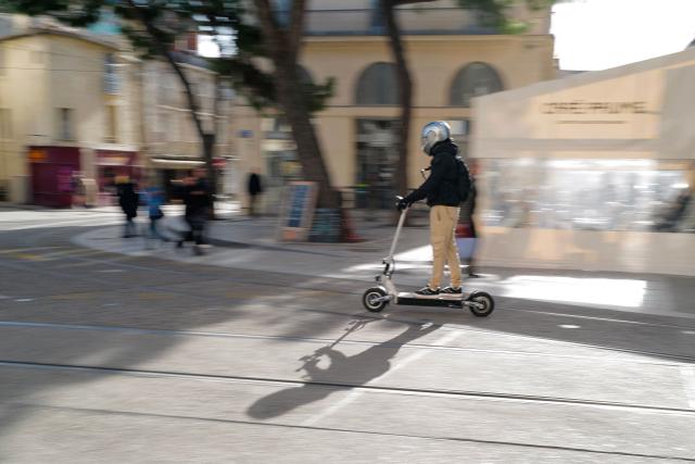 A person rides a scooter in Montpellier, southern France on February 11, 2026. The city of Montpellier issued a decree on November 2025 banning the use of electric scooters and similar vehicles in the Place de la Comédie, the Antigone district, and the main pedestrian streets of the historic center. (Photo by Sylvain THOMAS / AFP)