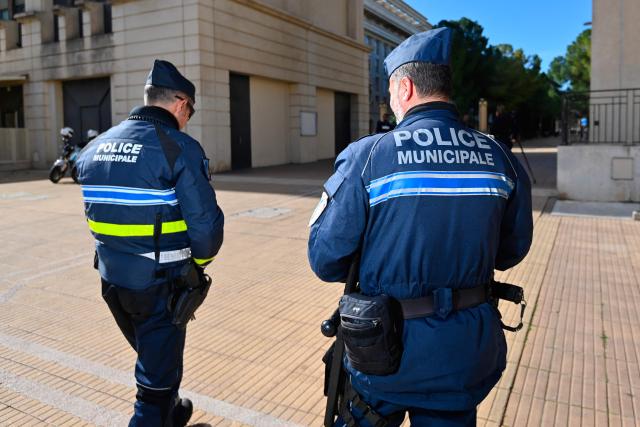 Local police officers stand guard in Montpellier, southern France on February 11, 2026. The city of Montpellier issued a decree on November 2025 banning the use of electric scooters and similar vehicles in the Place de la Comédie, the Antigone district, and the main pedestrian streets of the historic center. (Photo by Sylvain THOMAS / AFP)