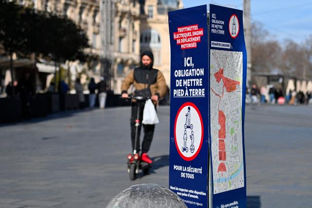 A man rides a scooter across Place de la Comédie in Montpellier, southern France on February 11, 2026. The city of Montpellier issued a decree on November 2025 banning the use of electric scooters and similar vehicles in the Place de la Comédie, the Antigone district, and the main pedestrian streets of the historic center. (Photo by Sylvain THOMAS / AFP)