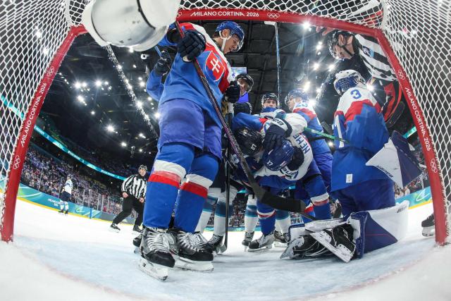 Slovakia's #17 Simon Nemec and Finland's #27 Eetu Luostarinen fight during the men's preliminary round Group B Ice Hockey match between Slovakia and Finland at the Milano Santagiulia Ice Hockey Arena during the Milano Cortina 2026 Winter Olympic Games in Milan, on February 11, 2026. (Photo by POOL / AFP)