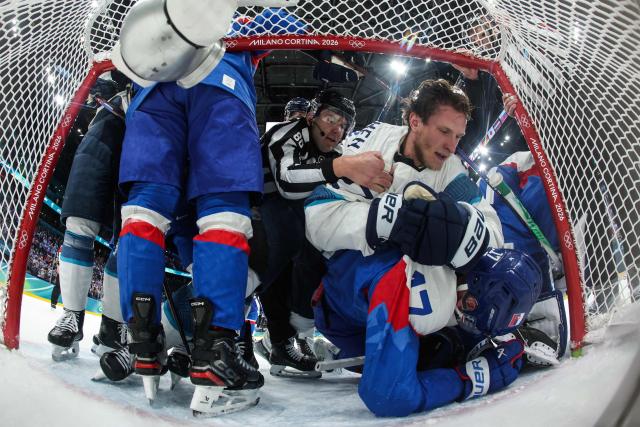 Slovakia's #17 Simon Nemec (dwon) and Finland's #27 Eetu Luostarinen (up) fight during the men's preliminary round Group B Ice Hockey match between Slovakia and Finland at the Milano Santagiulia Ice Hockey Arena during the Milano Cortina 2026 Winter Olympic Games in Milan, on February 11, 2026. (Photo by POOL / AFP)