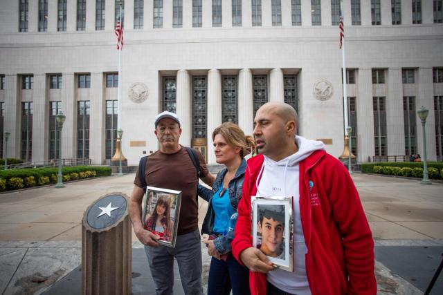 Parents from the United Kingdom George Nicolaou (L) Mariano Janin (C), and Ellen Roome Cheltenham (R) arrive holding photos of their children who took their own lives outside the Los Angeles County Superior Court in Los Angeles, on February 11, 2026. Arguments began February 9 in a landmark US trial that could establish a legal precedent on whether social media companies deliberately designed their platforms to lead to addiction in children. The case in Los Angeles Superior Court is being seen as a bellwether proceeding because its outcome could set the tone for a tidal wave of similar litigation across the United States. (Photo by Apu GOMES / AFP)