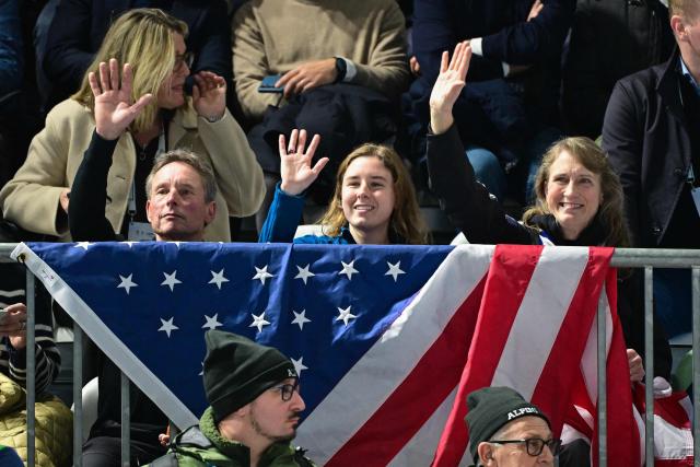 Family members of USA's Jordan Stolz wave at the speed skating men's 1000m event during the Milano Cortina 2026 Winter Olympic Games at Milano Speed Skating Stadium in Milan on February 11, 2026. (Photo by Piero CRUCIATTI / AFP)