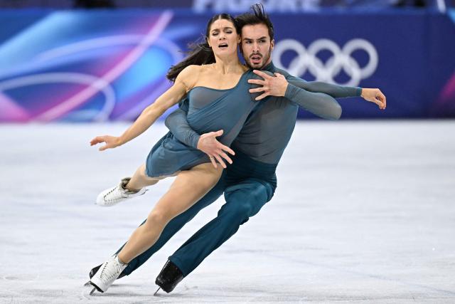 France's Laurence Fournier Beaudry (L) and France's Guillaume Cizeron warm up before the figure skating ice dance-free dance final during the Milano Cortina 2026 Winter Olympic Games at Milano Ice Skating Arena in Milan on February 11, 2026. (Photo by Gabriel BOUYS / AFP)
