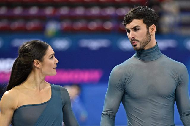 France's Laurence Fournier Beaudry (L) and France's Guillaume Cizeron warm up before the figure skating ice dance-free dance final during the Milano Cortina 2026 Winter Olympic Games at Milano Ice Skating Arena in Milan on February 11, 2026. (Photo by Gabriel BOUYS / AFP)