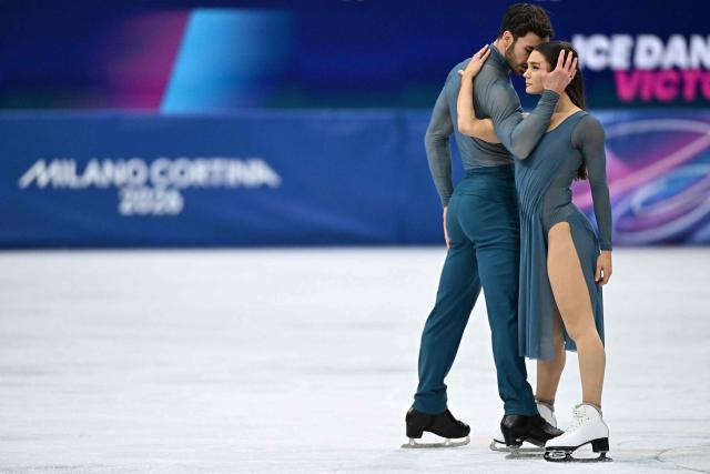 France's Laurence Fournier Beaudry (R) and France's Guillaume Cizeron warm up before the figure skating ice dance-free dance final during the Milano Cortina 2026 Winter Olympic Games at Milano Ice Skating Arena in Milan on February 11, 2026. (Photo by Gabriel BOUYS / AFP)