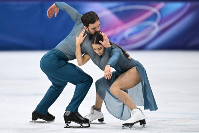 France's Laurence Fournier Beaudry (R) and France's Guillaume Cizeron warm up before the figure skating ice dance-free dance final during the Milano Cortina 2026 Winter Olympic Games at Milano Ice Skating Arena in Milan on February 11, 2026. (Photo by Gabriel BOUYS / AFP)