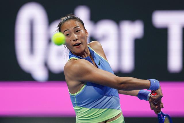 China’s Zheng Qinwen hits a return against Kazakhstan's Elena Rybakina during their women’s singles match at the Qatar Open tennis tournament in Doha on February 11, 2026. (Photo by Karim JAAFAR / AFP)