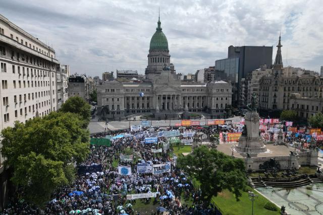 In this aerial view trade unionists protest against the labor reform debate taking place in the National Congress in Buenos Aires, on February 11, 2026. (Photo by Luis ROBAYO / AFP)