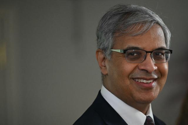 US National Institutes of Health (NIH) Director Jayanta (Jay) Bhattacharya  looks on US First Lady Melania Trump visits the Children's Inn at National Institutes of Health (NIH) in Bethesda, Maryland, on February 11, 2026. (Photo by ANDREW CABALLERO-REYNOLDS / AFP)