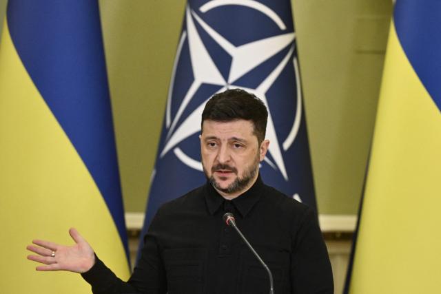 (FILES) Ukraine's President Volodymyr Zelensky gestures as he delivers a press conference with Secretary General of NATO following their meeting in Kyiv on February 3, 2026, amid the Russian invasion in Ukraine. Zelensky said on February 11, 2026 that Ukraine would only hold elections after a ceasefire with Moscow and the provision of ‘security guarantees’, responding to reports that Kiev was planning a presidential election and a referendum in the near future. (Photo by Genya SAVILOV / AFP)