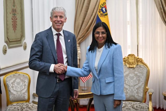 US Secretary of Energy Chris Wright (L) shakes hands with Venezuela's acting president Delcy Rodriguez before a meeting at the Miraflores Presidential Palace in Caracas on February 11, 2026. US Energy Secretary Chris Wright arrived in Venezuela on February 11 for talks with acting president Delcy Rodriguez and oil industry executives on harnessing the country's vast crude reserves. (Photo by Juan BARRETO / AFP)